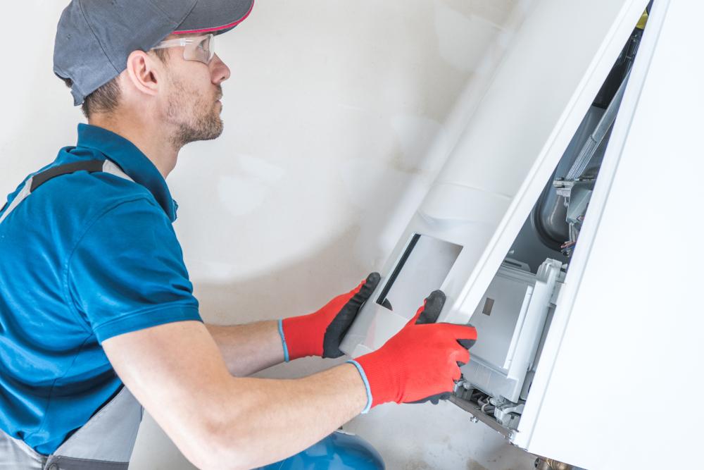 Man replacing panel of a furnace