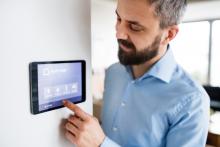 man changing smart thermostat, smart thermostat, home comfort