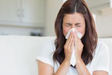 woman at home sneezing