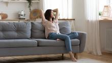 woman breathing fresh air at home on couch