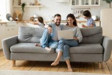 Happy family looking at laptop