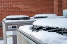 hvac outdoor unit covered in snow