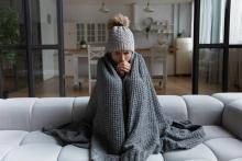 Woman cold in her home with a blanket