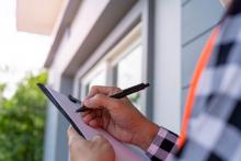 person with a clipboard writing something down