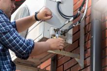 Repairman working on an AC Unit