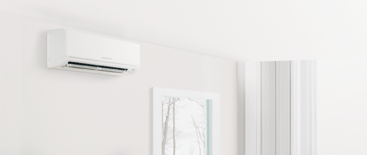 family sitting together under an air conditioner