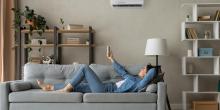 woman laying on a couch using a heat pump