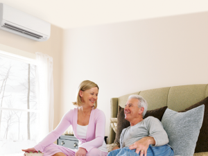 A couple sitting under a heat pump