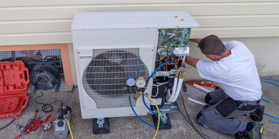 Man fixing a heat pump