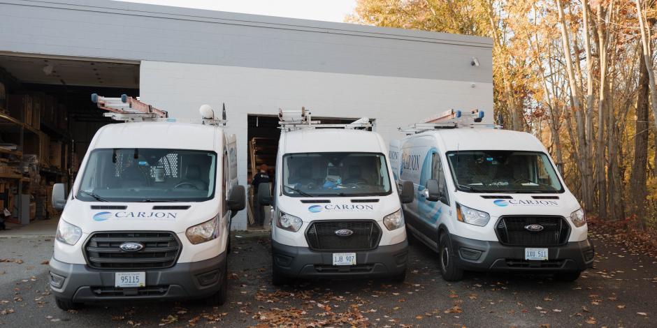 three carjon vans in parking lot