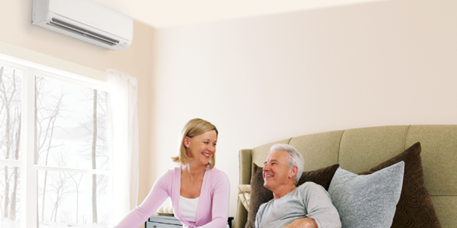 A couple sitting under a heat pump