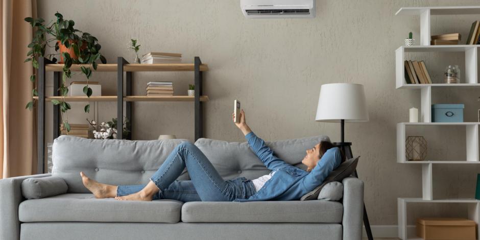 woman laying on a couch using a heat pump