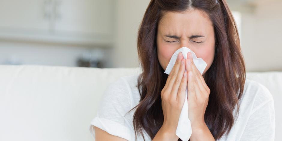 woman at home sneezing