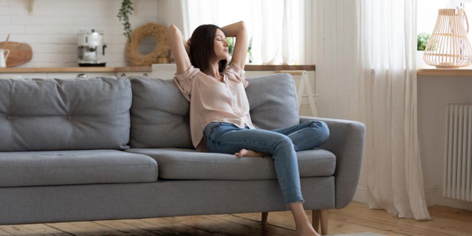 woman breathing fresh air at home on couch