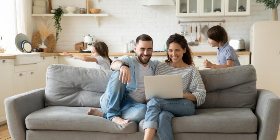 Happy family looking at laptop