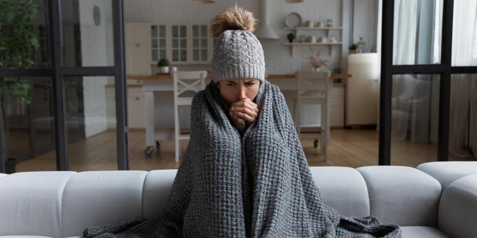 Woman cold in her home with a blanket