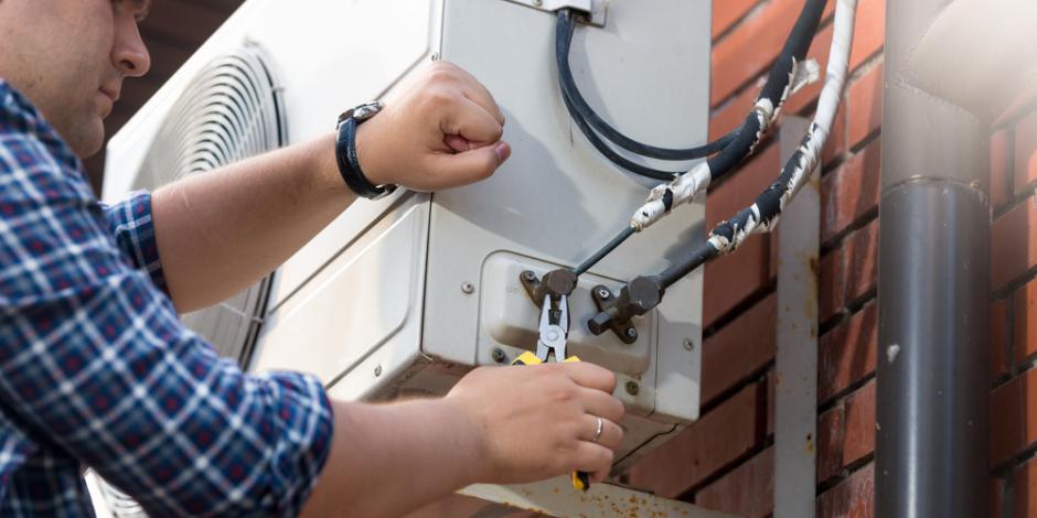 Repairman working on an AC Unit