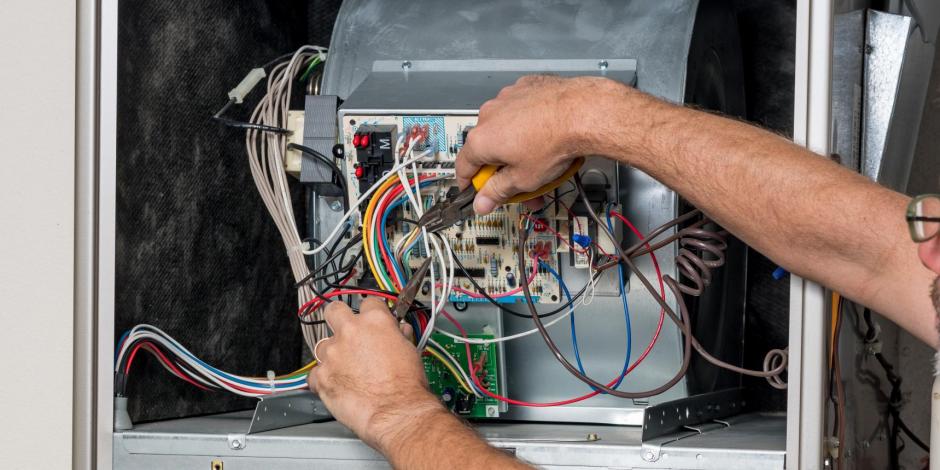 man working on a furnace